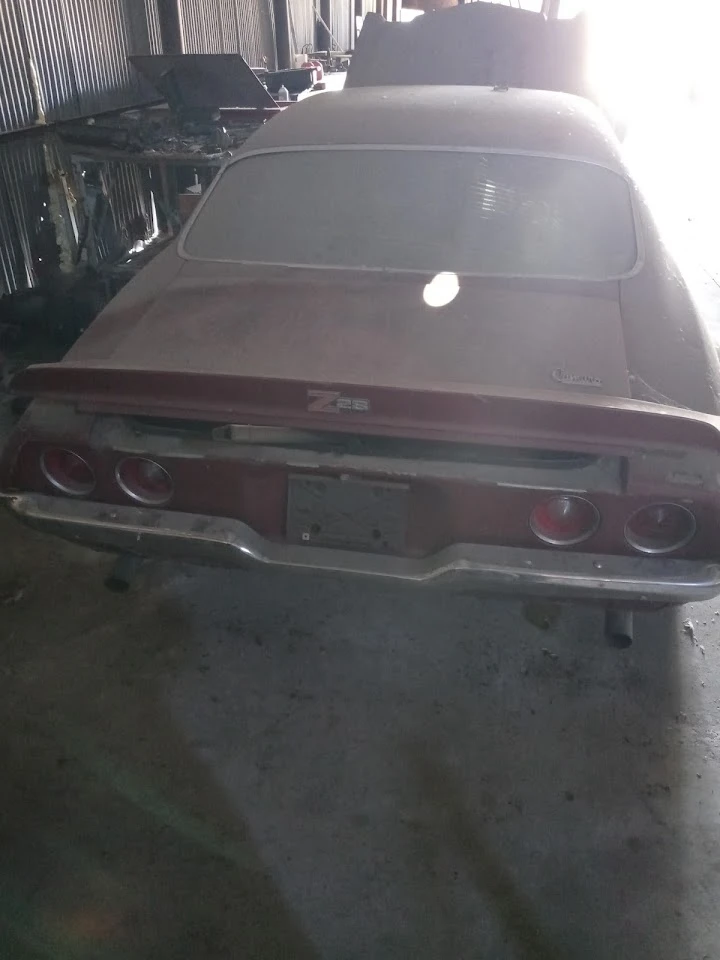 Dusty car in an auto salvage yard.