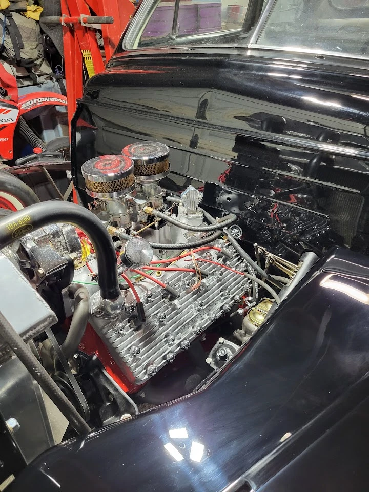 Engine bay of a classic car with performance parts.