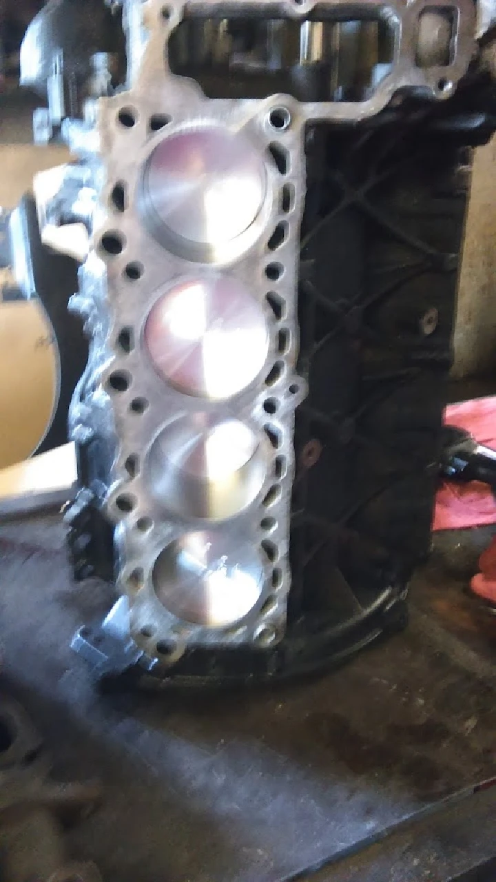 Engine block with polished pistons visible.