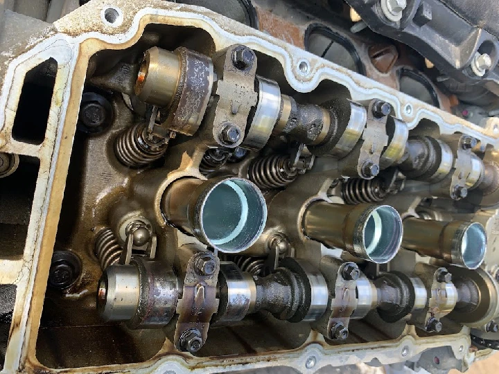 Engine cylinder head with valves and springs.