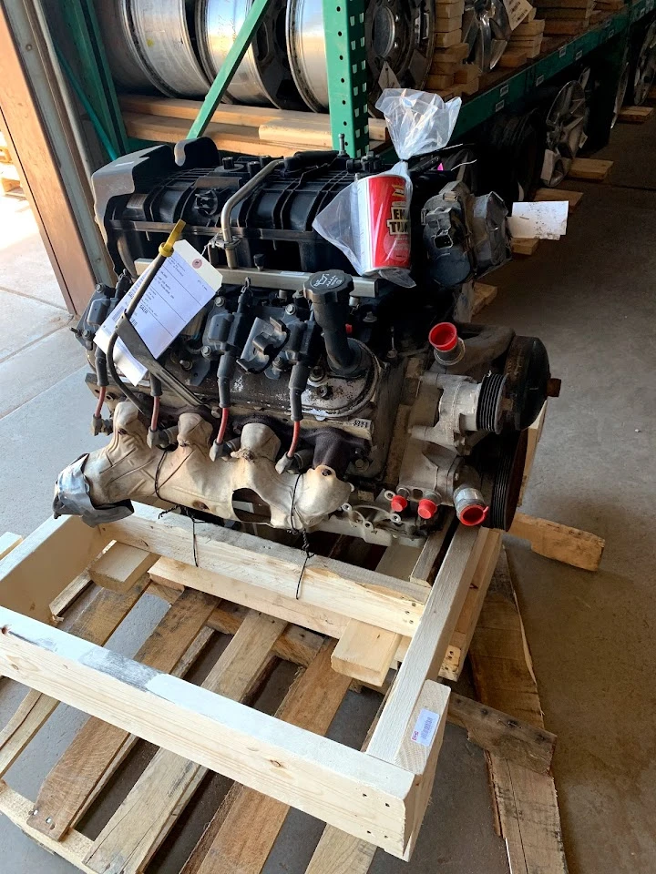 Engine on wooden pallet at H & H Salvage Yard.