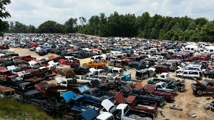 Expansive junkyard filled with various vehicles.