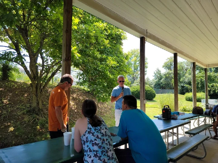 Group discussion in a sunny outdoor setting.