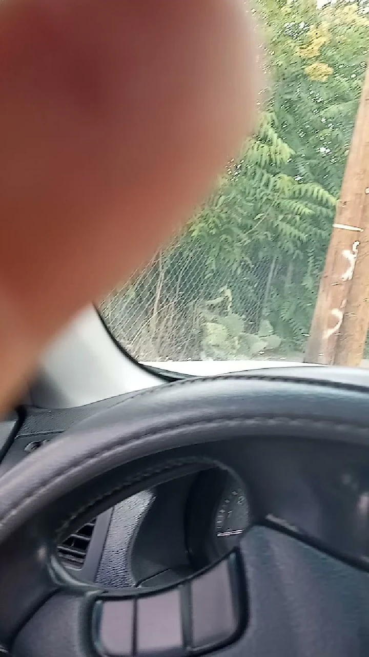 Inside a car with part of a finger in the frame.