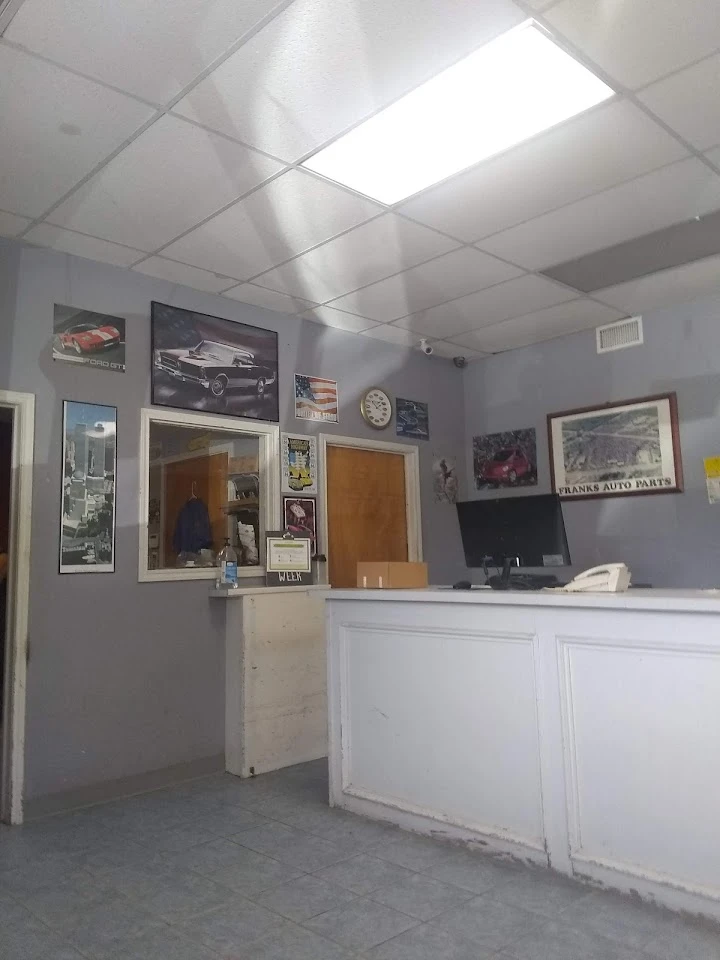 Inside Frank's Auto Parts office, displays on walls.