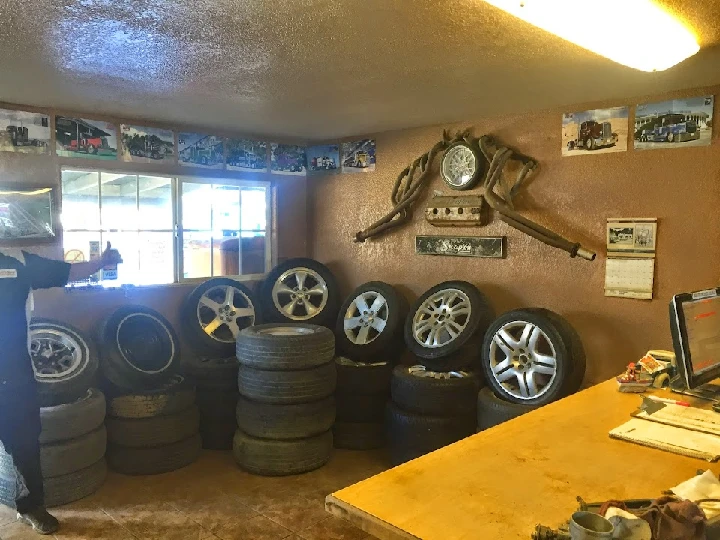 Interior of Ace Auto Wreckers with stacked tires.