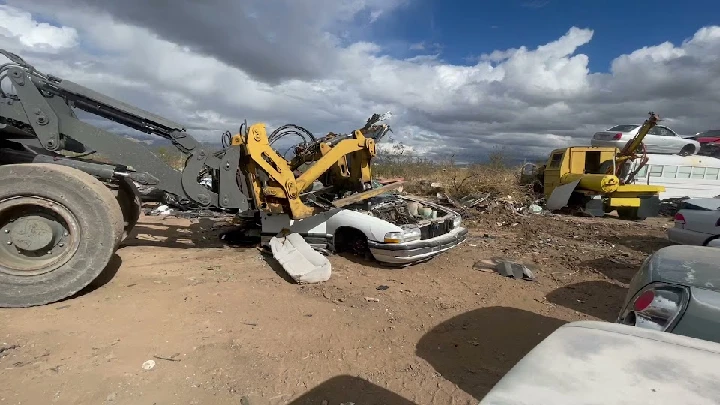 Junk cars being processed in a scrapyard.