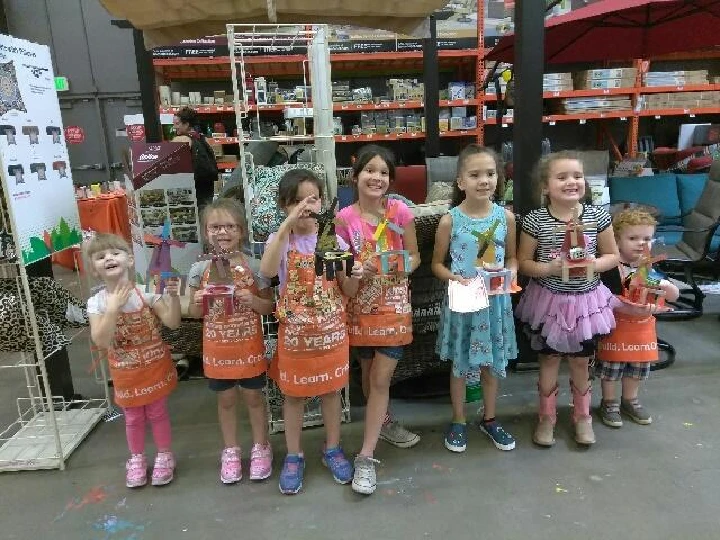 Kids displaying crafts at a workshop event.