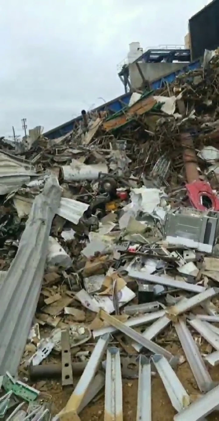 Large pile of scrap metal and debris at a recycling site.