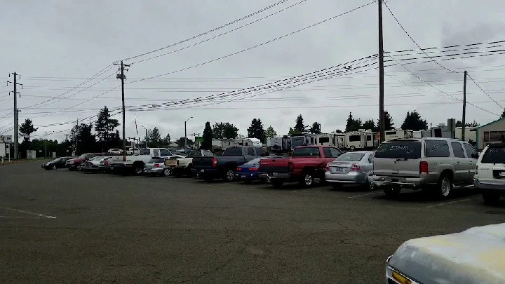 Parking lot with various vehicles at B&R Auto Wrecking.