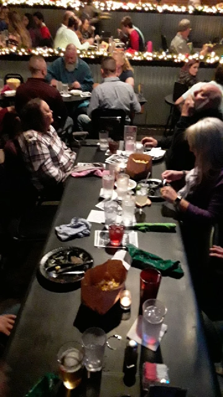 People dining in a lively restaurant setting.