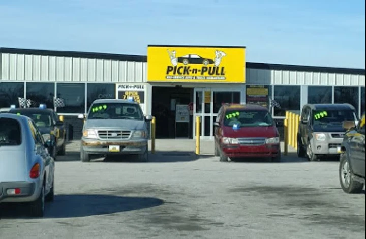 Pick-n-Pull salvage yard entrance with vehicles outside.