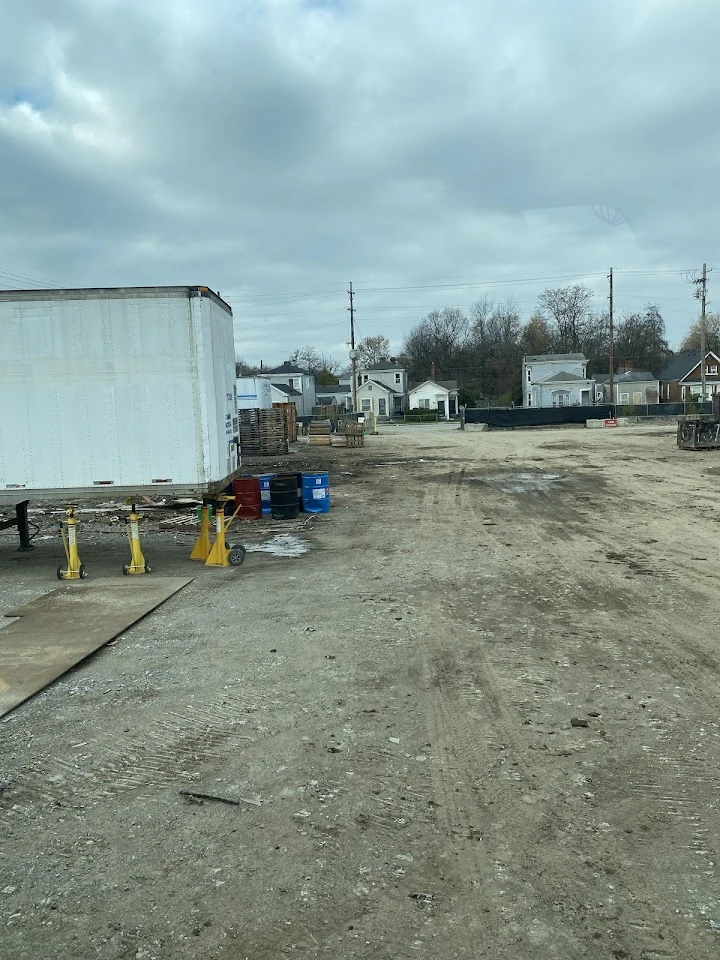 Recycling facility with storage containers and pallets.