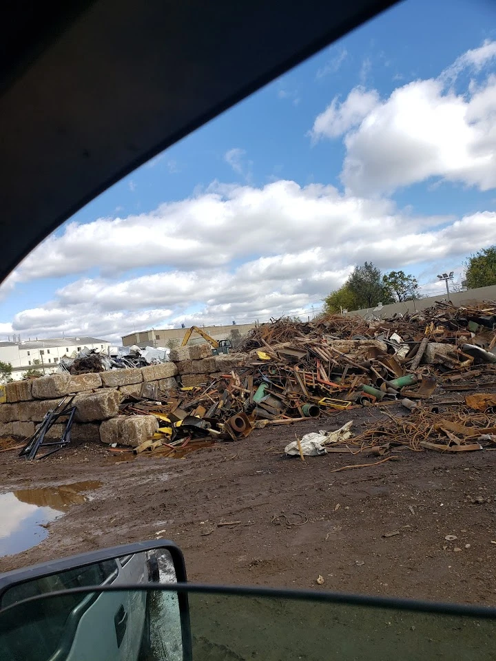 Scrapyard with piles of metal and debris.