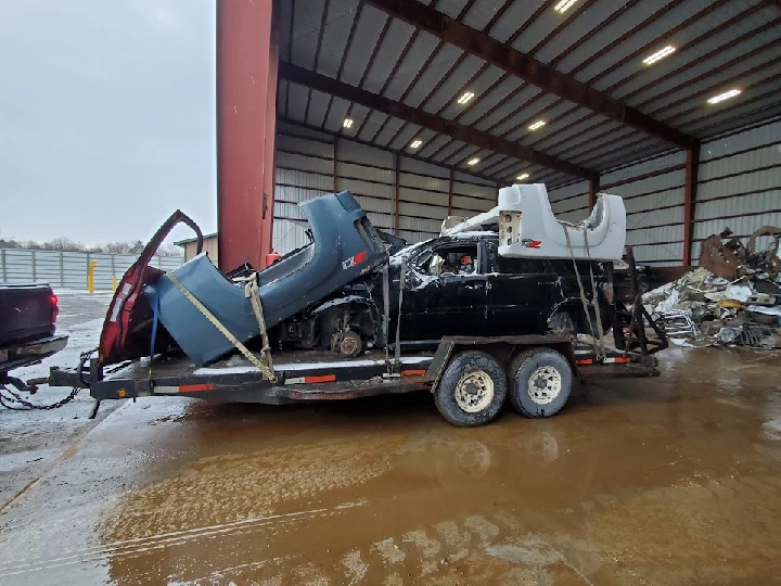 Scrapyard trailer loaded with vehicle parts.