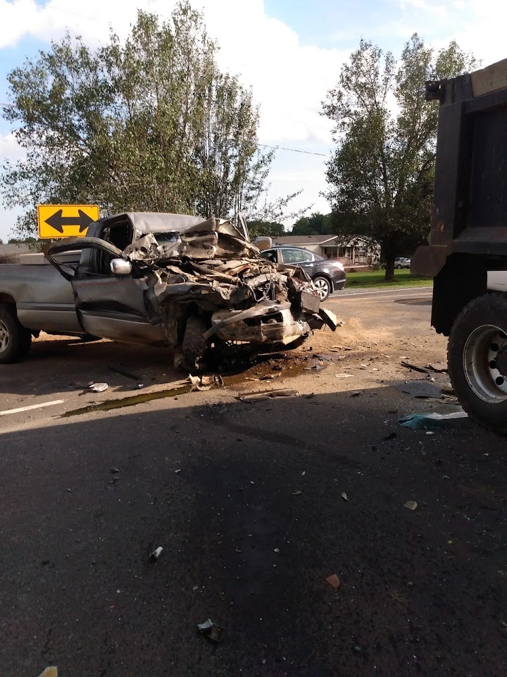 Severely damaged vehicle at an accident scene.