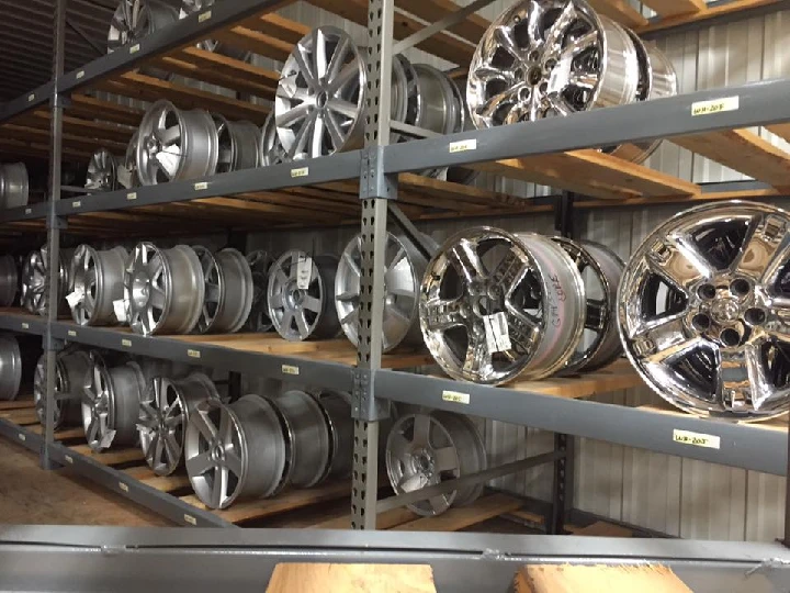 Shelves of various car rims at B Auto Parts.