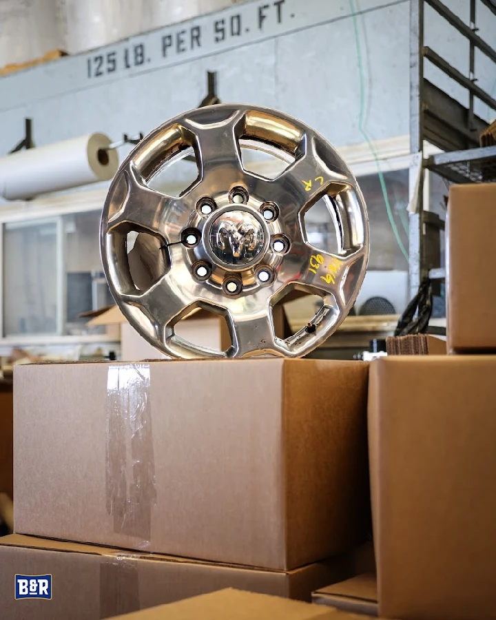 Shiny wheel on boxes at auto parts shop.