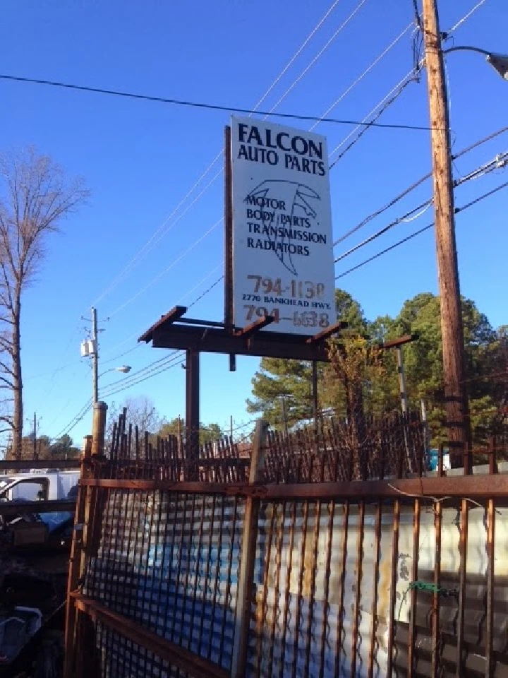 Sign for Falcon Auto Parts showcasing services offered.