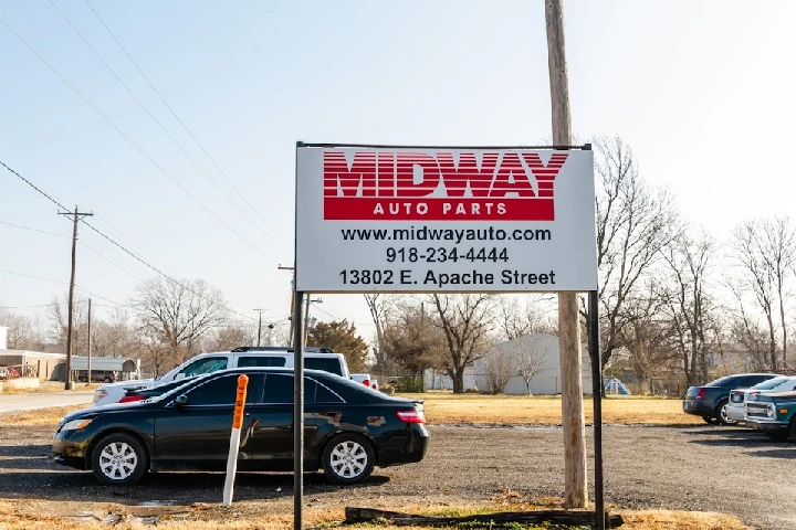 Sign for Midway Auto Parts on Apache Street.