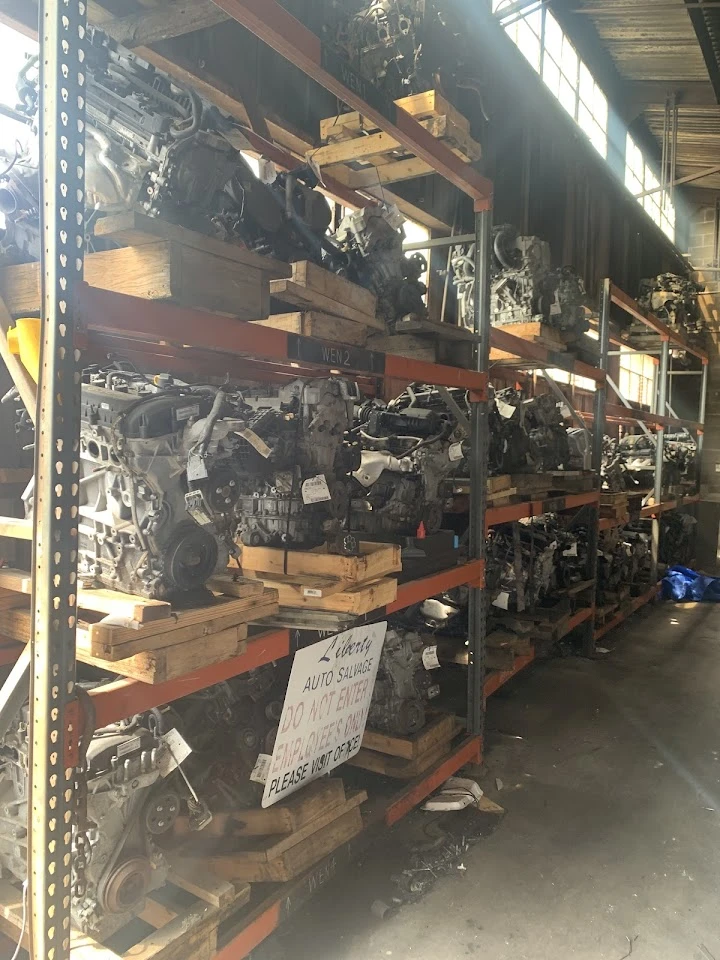 Storage area filled with used auto parts and engines.