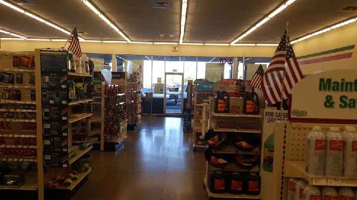 Store interior with shelves and American flags.