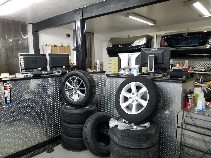 Tires and computers in a garage setting.