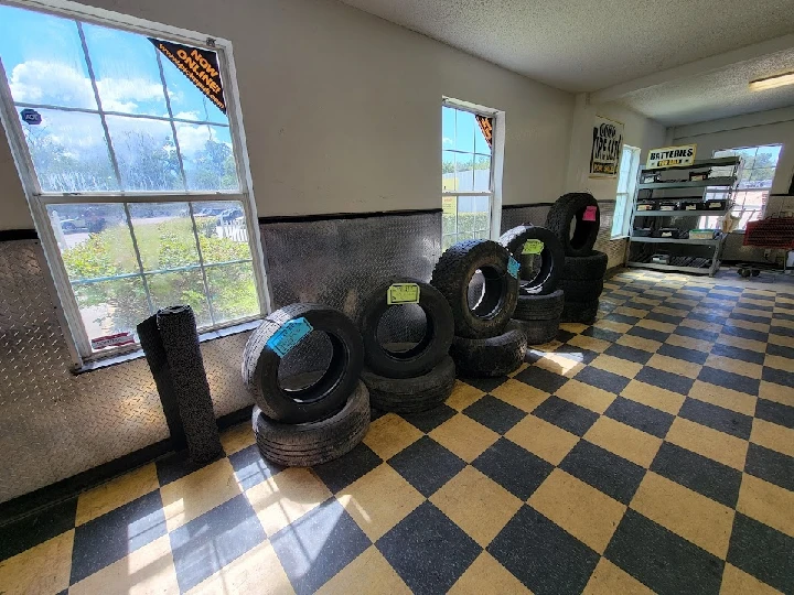 Tires displayed in a bright, tiled shop interior.