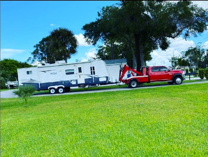 Tow truck hauling a camper in St. Petersburg, FL.