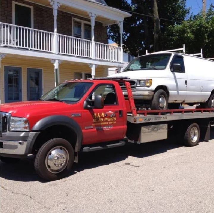 Tow truck with a van, A & A Auto Parts logo visible.