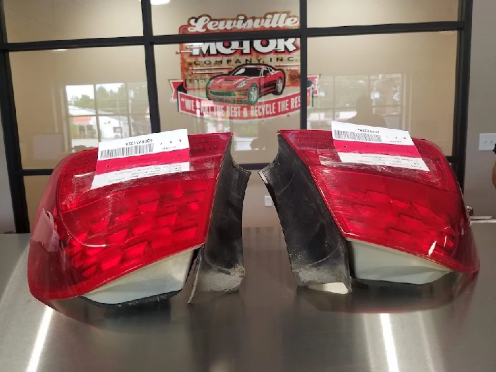 Two car taillights on a display table.