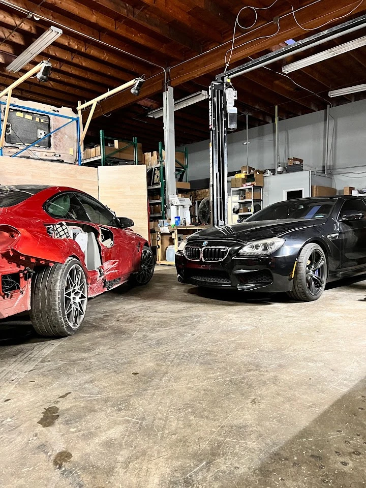 Two cars in an auto parts shop garage.