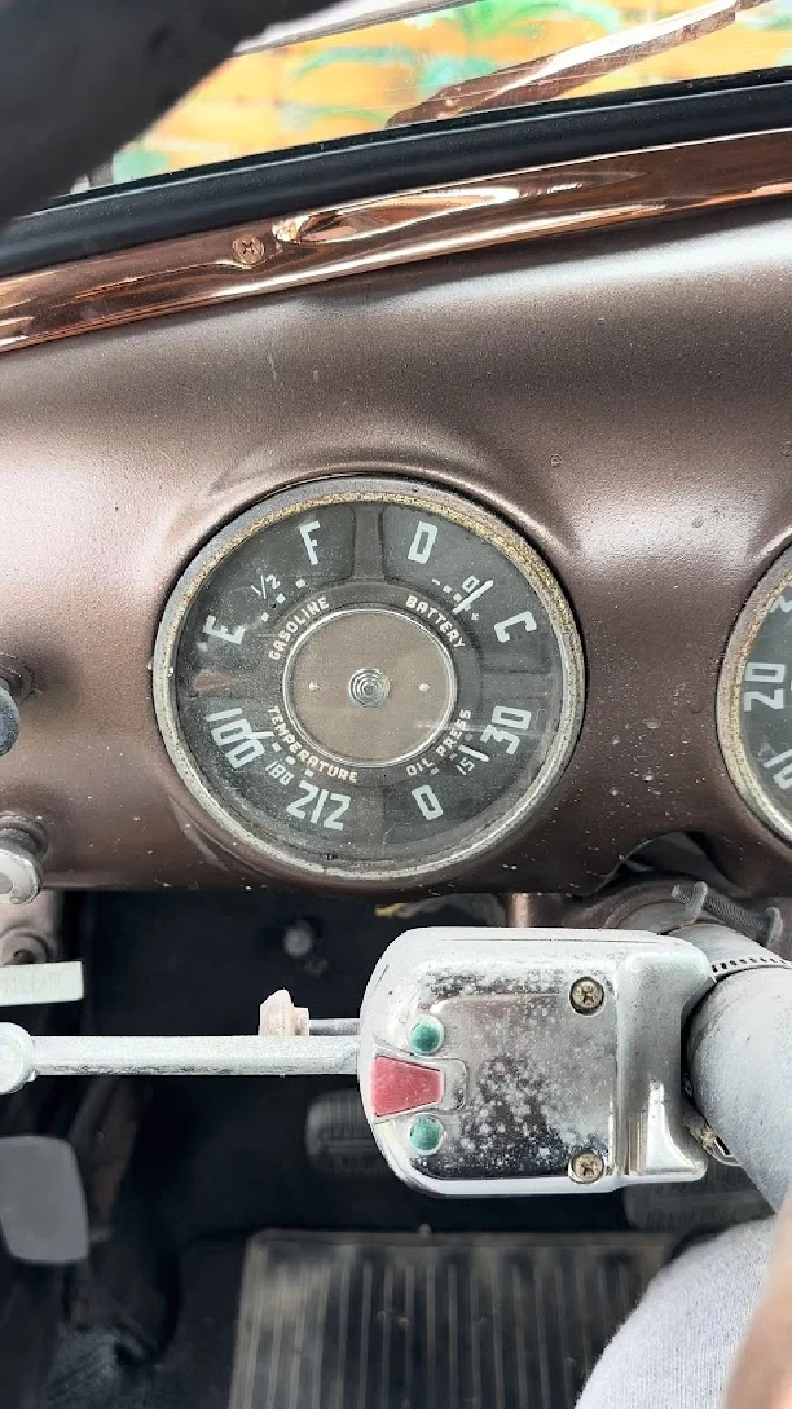 Vintage truck dashboard with gauges and controls.