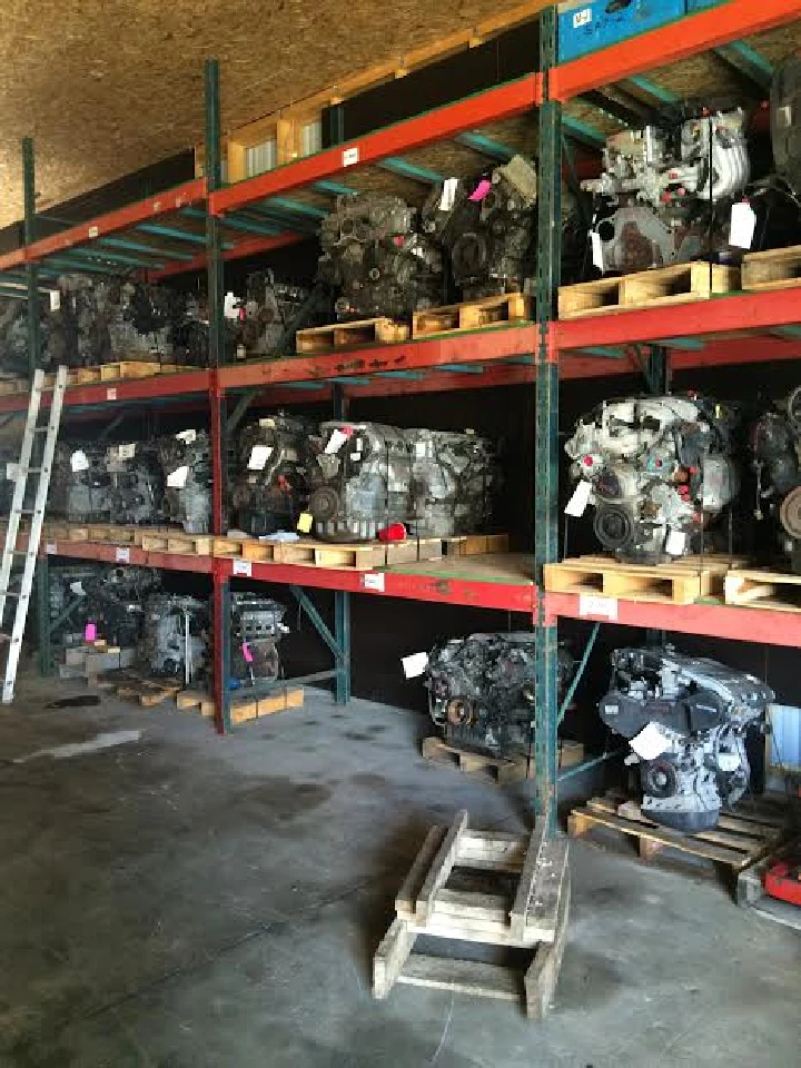 Warehouse with rows of used engines on shelves.