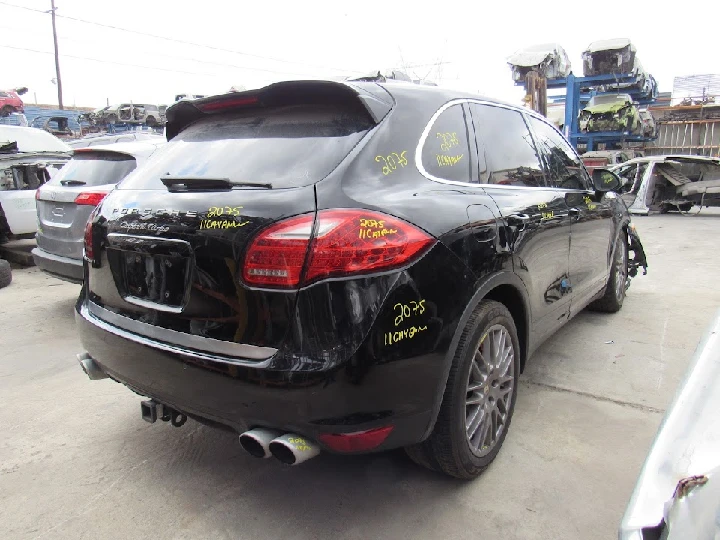 Black Porsche Cayenne Turbo in a salvage yard.