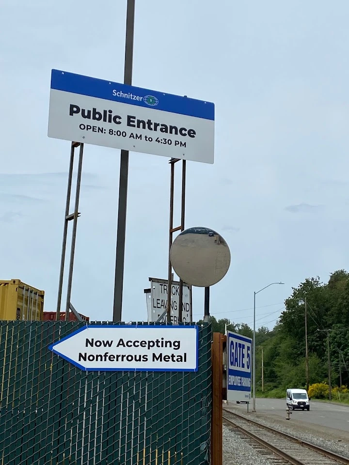 Entrance sign for Radius Recycling, operating hours.