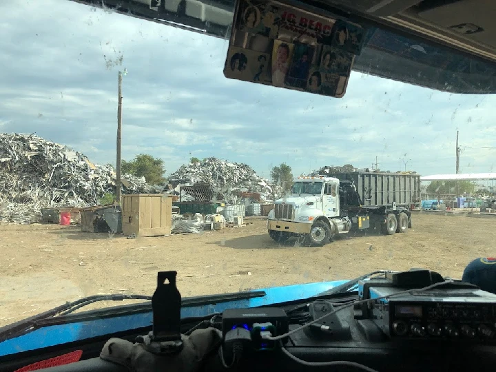 View of a scrapyard from inside a truck.